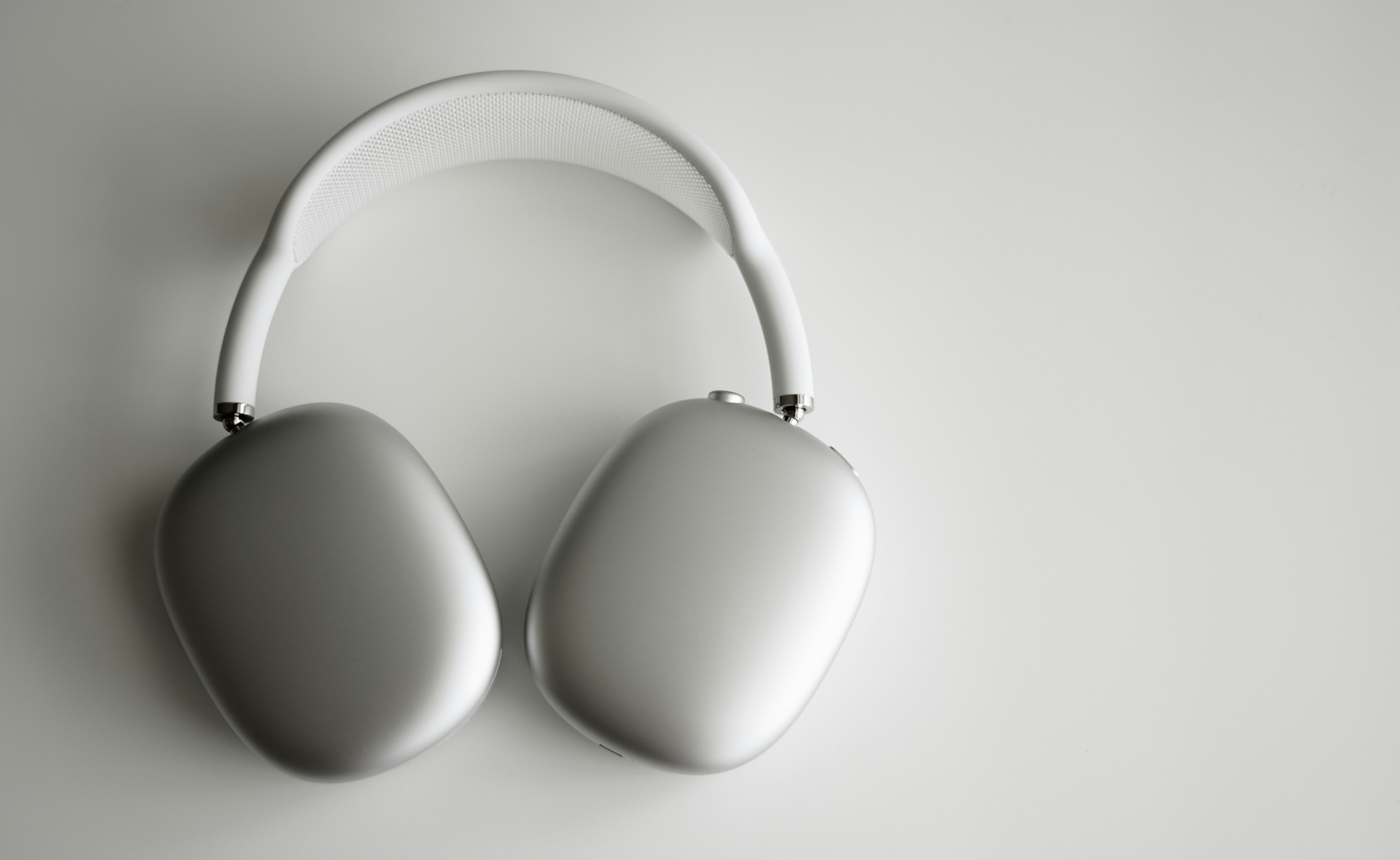 white wireless headphones on white table